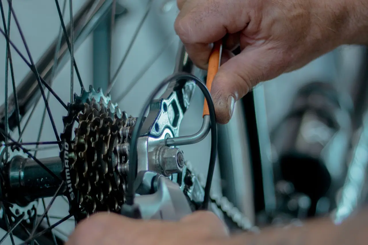 Mechanic adjusting a bicycle drivetrain